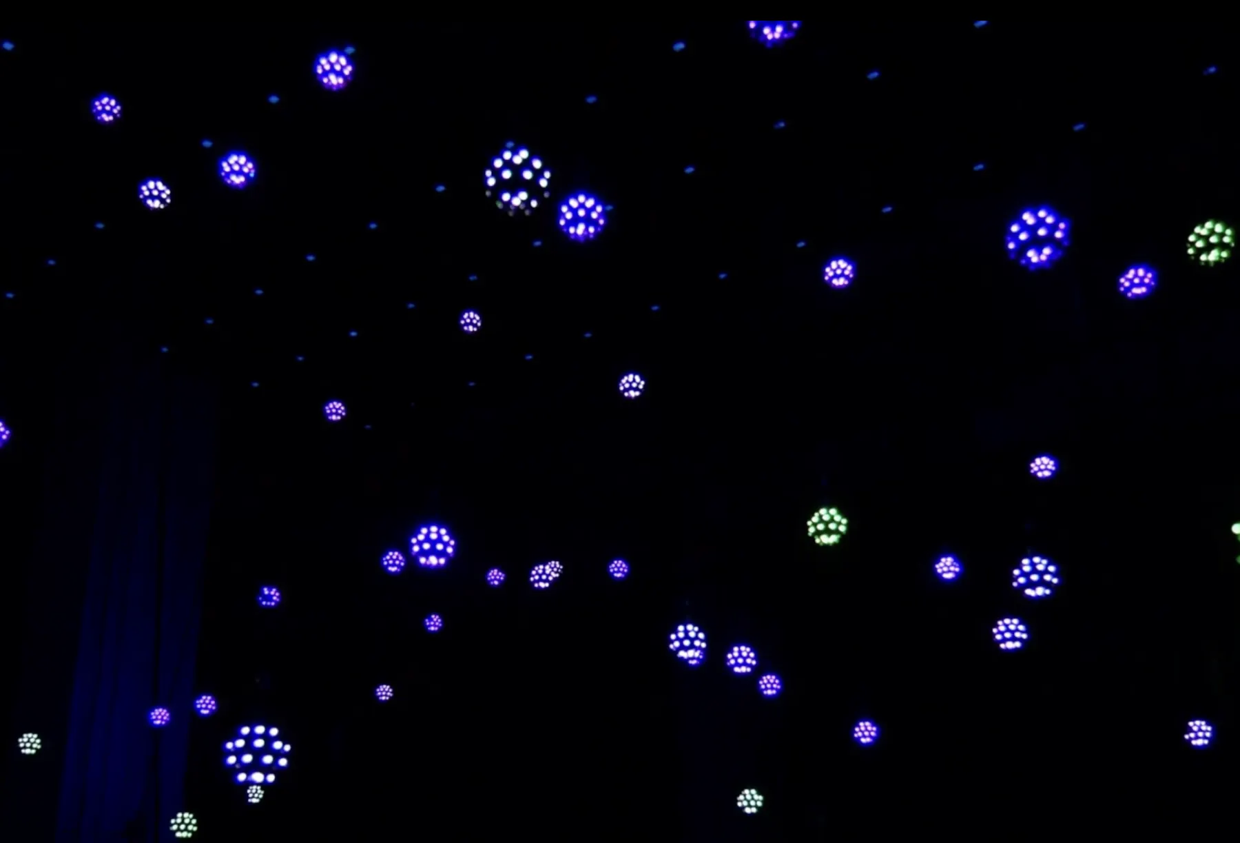 Mini orbs hanging in a dark room